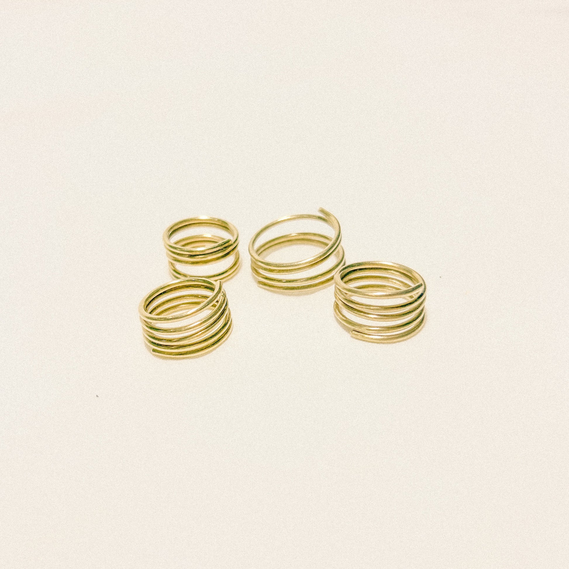 Set of gold spiral rings on a white background