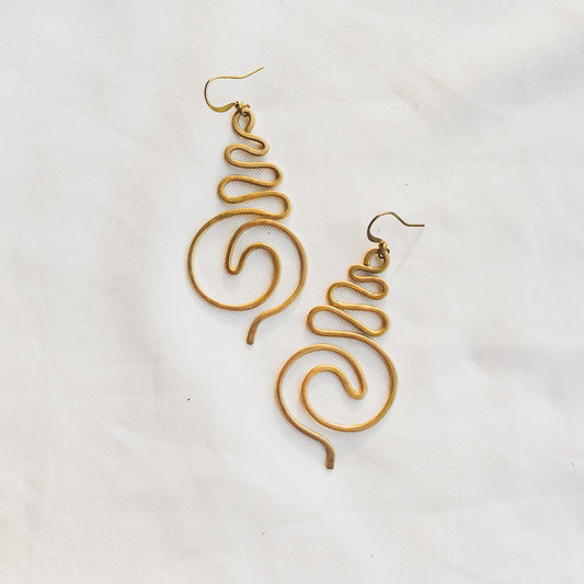 Gold spiral earrings on a white background